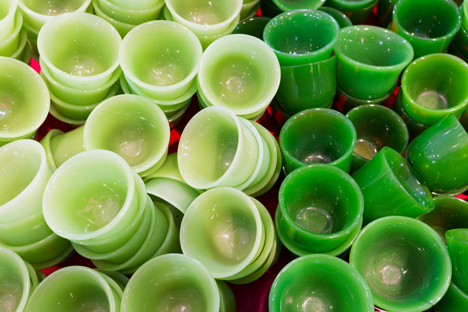 A pile of green cups sitting on top of a table