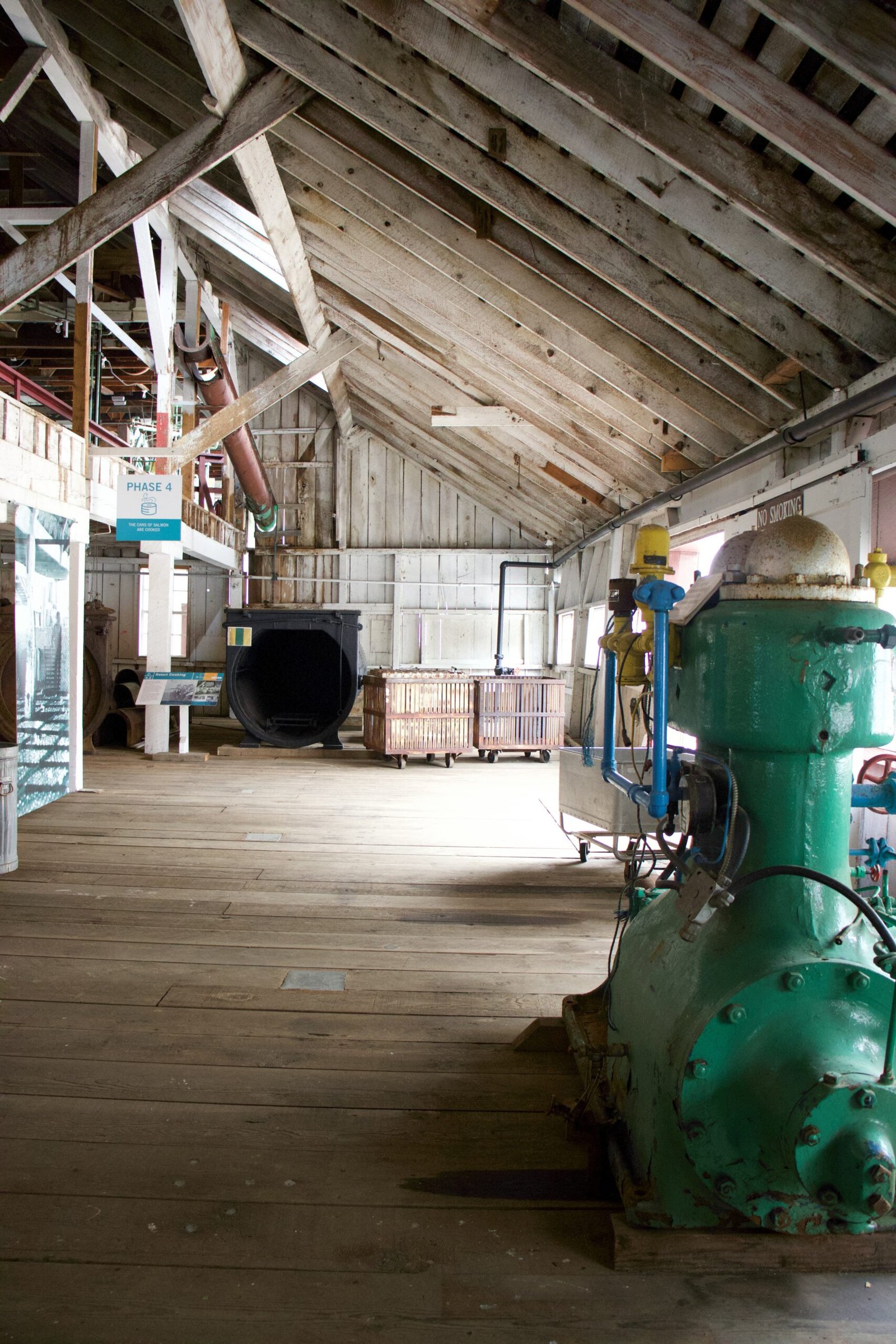 a large warehouse with a green tractor